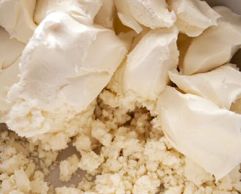 Blend together cream cheese and feta cheese just until combined